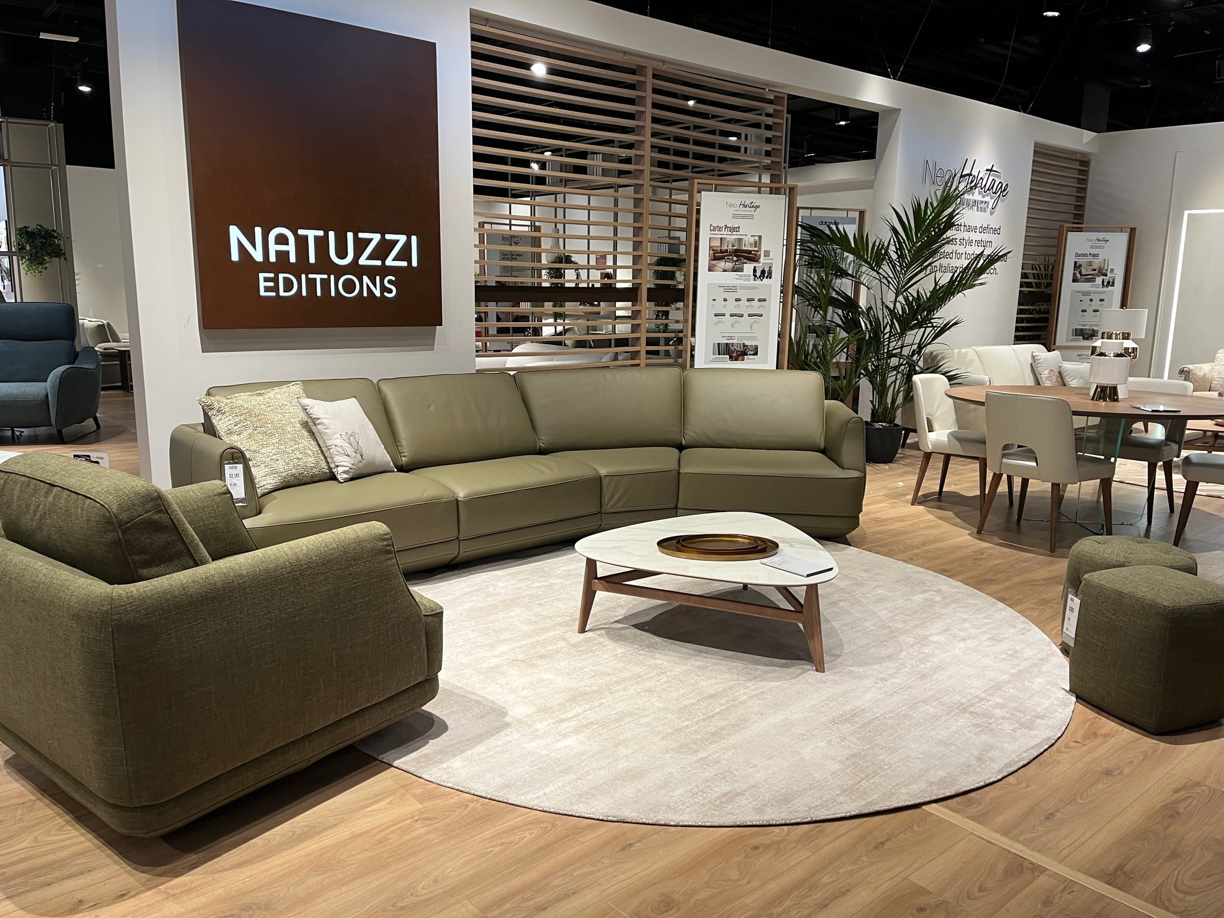 Natuzzi showroom presentation at High Point Market, upholstery groupings staged for buyer walkthroughs.
