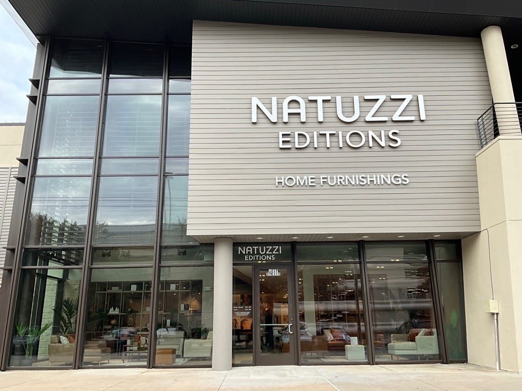 Natuzzi Editions sales floor on opening day, upholstery groupings arranged along the main sightline.
