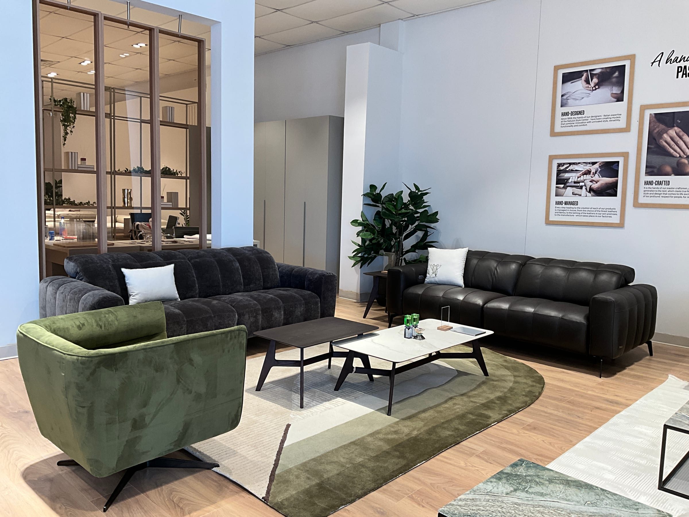 Velvet and leather sofa grouping staged in front of the brand's hand-crafted heritage photo wall.