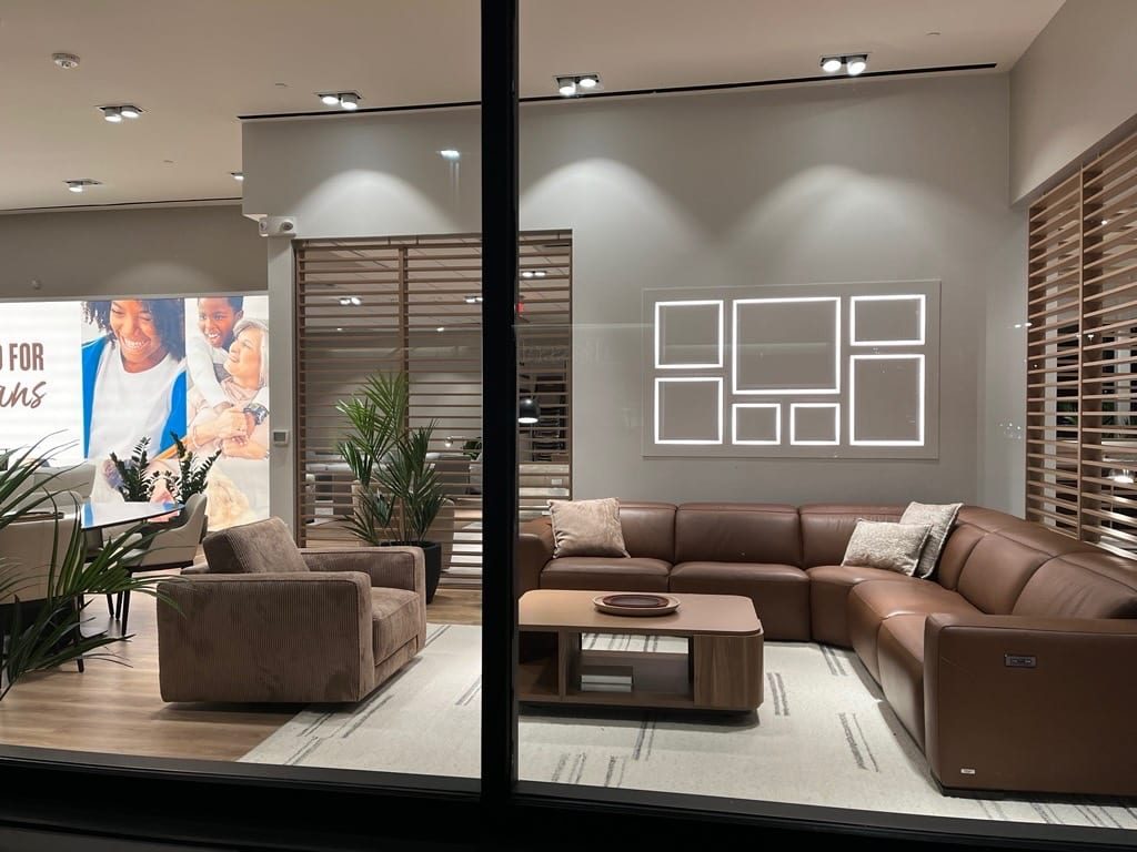 Install in progress on a Natuzzi Editions floor, crew positioning a large sectional.